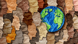 Multicolored cut outs of different faces and Earth made out of construction paper