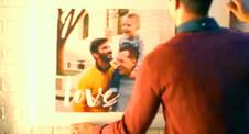A still image from Shutterfly's holiday ad showing two gay dads and their son.